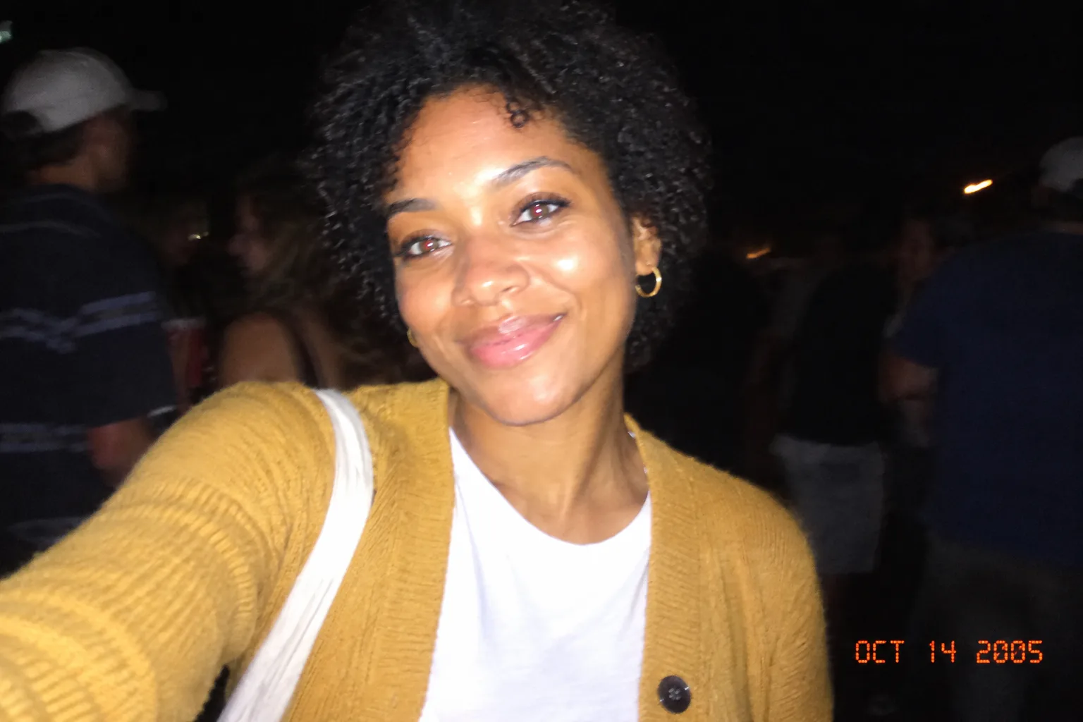 The same woman in a night party snapshot with harsh flash, mild red-eye and an orange date stamp in the corner